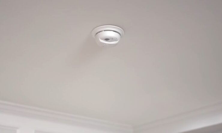 A white ceiling light fixture with a visible light bulb illuminating the space below