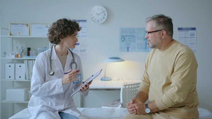 Doctor and patient discussing care decisions in a calm and structured clinical consultation