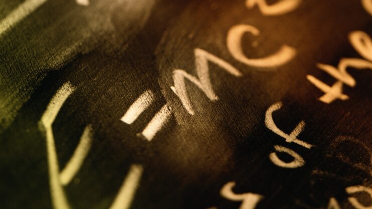 Close-up of chalkboard equations that show how physics problems depend on clear models rather than raw algebra