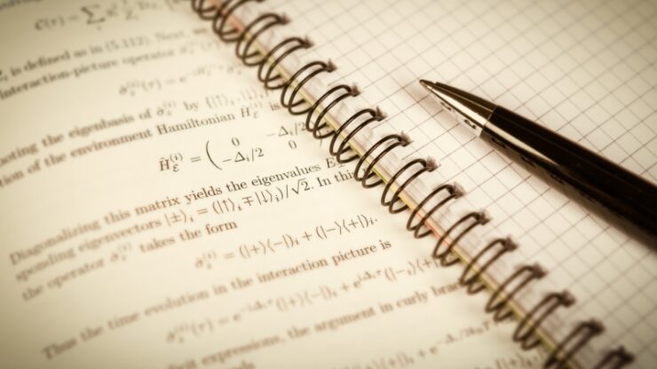 Notebook with physics equations and a pen captures why physics study often slips into memorization