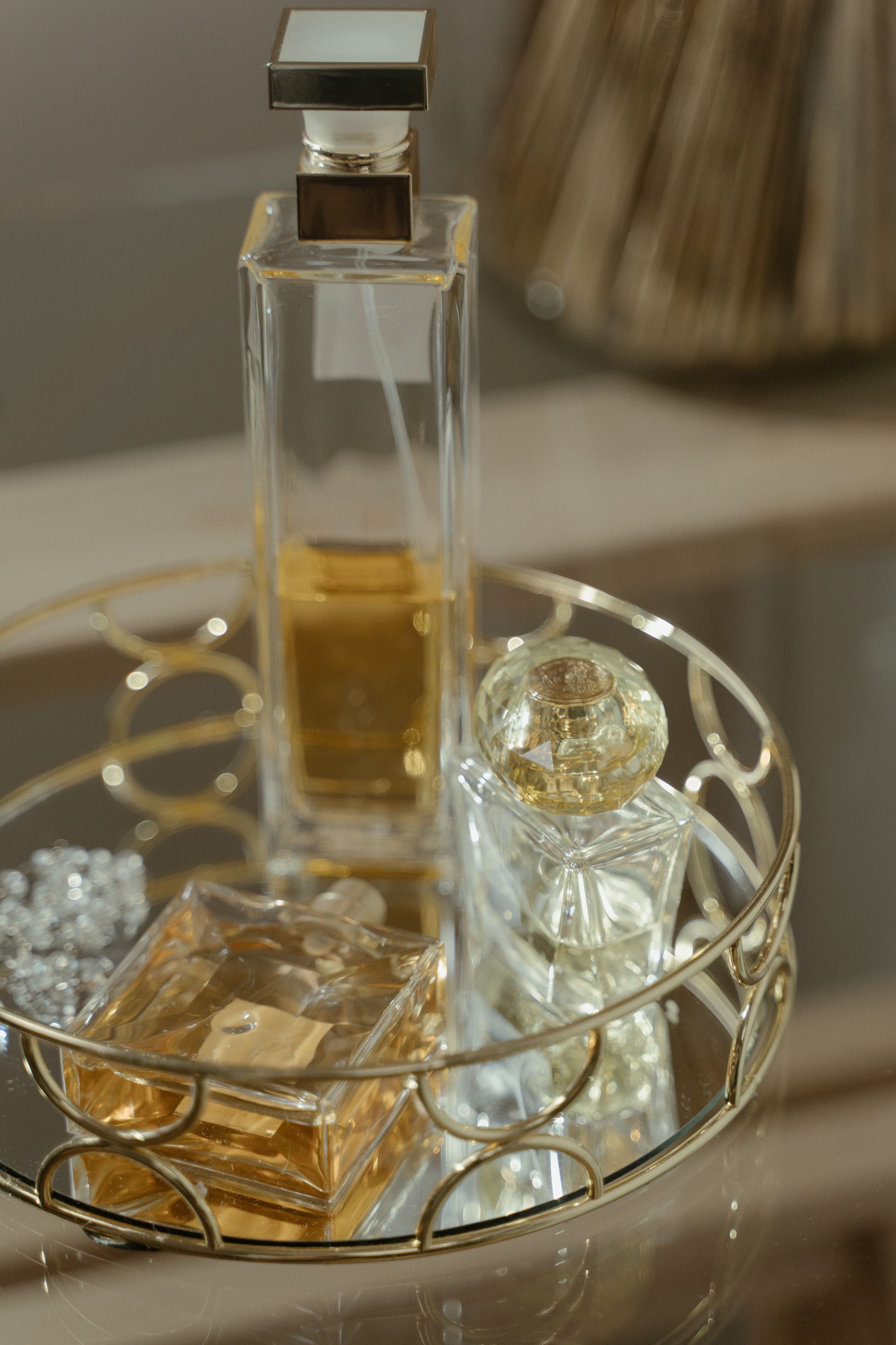 Luxurious perfume bottles elegantly arranged on a decorative tray, illustrating high-end luxury goods