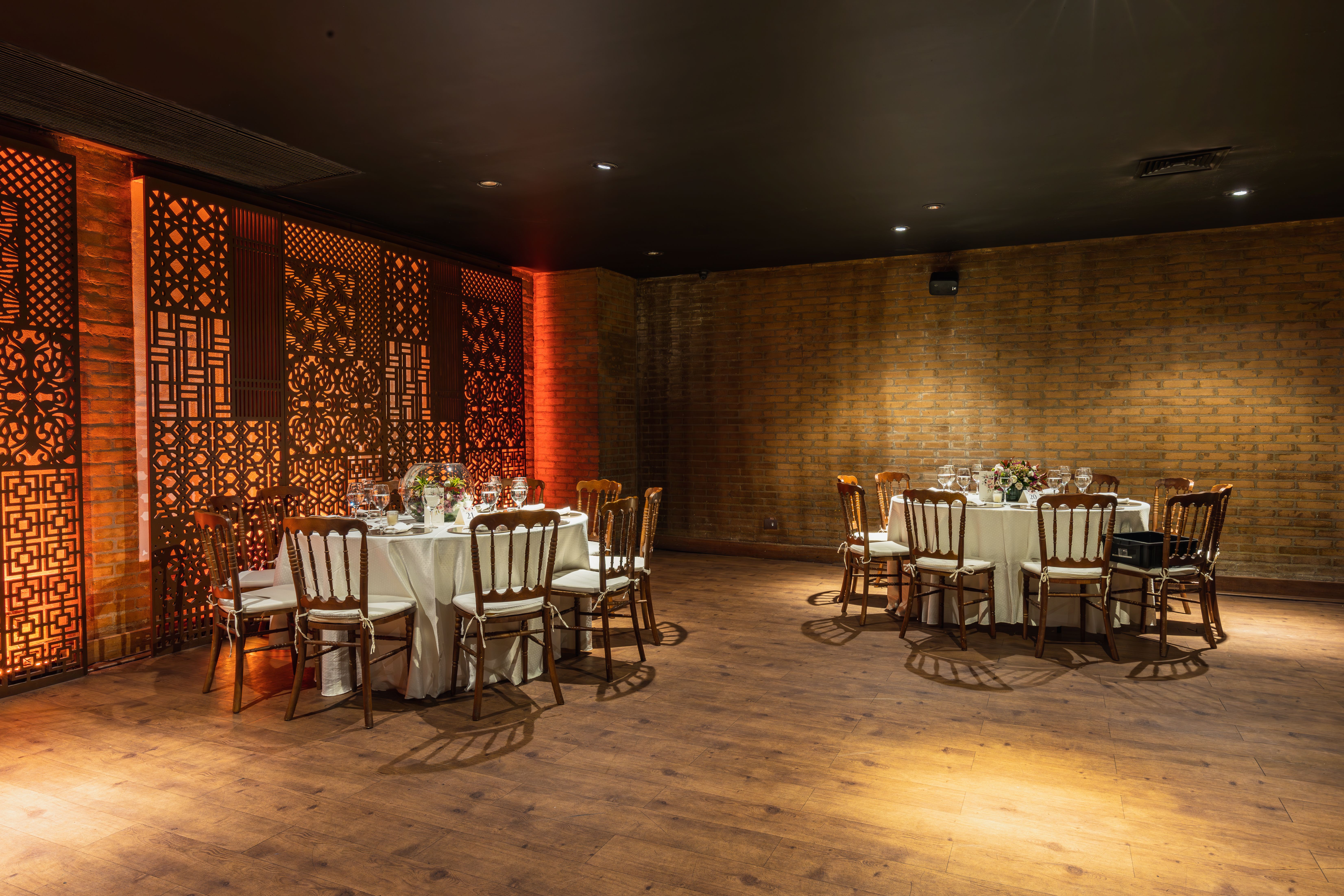 Luxurious dining room with latticework and elegant seating for a private event, highlighting exclusive discretion