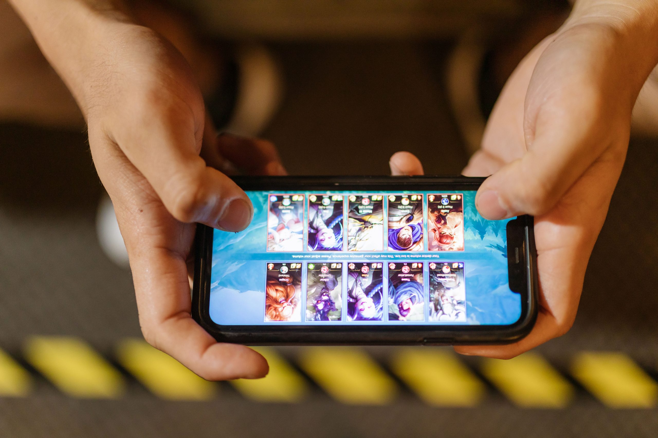 Close-up of hands playing a mobile game on a smartphone, illustrating the immediate visual feedback of Aviator-style gameplay.